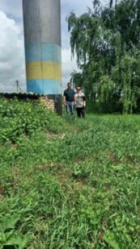 на фото дві людини біля водонапірної башти