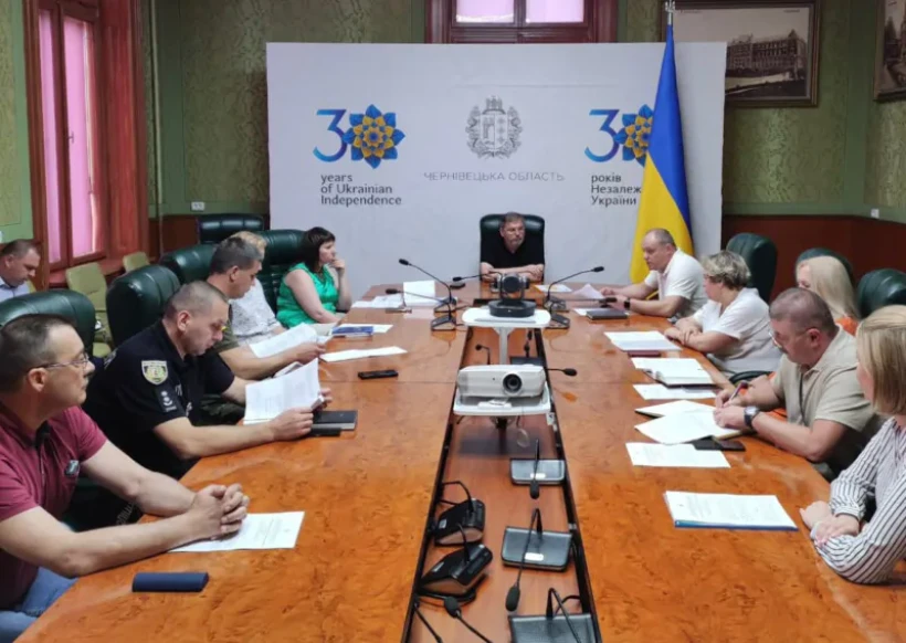 на фото зображені учасники заходу за довгим столом
