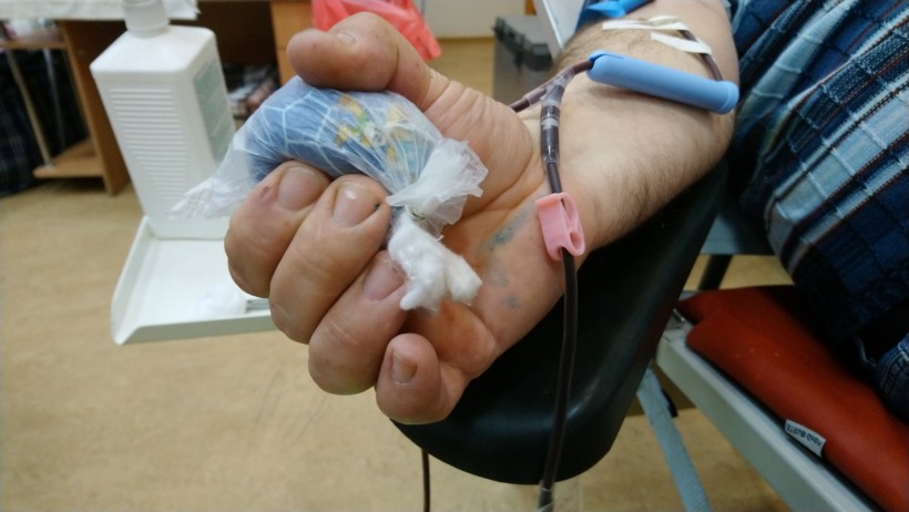 на малюнку долоня людини під час забору крові